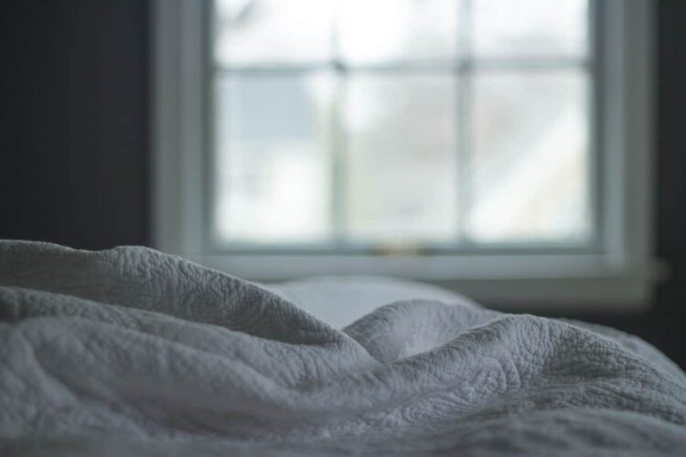 white linen bed sheet